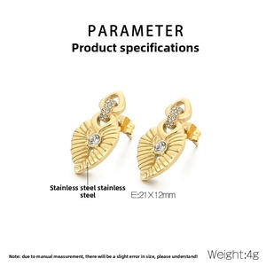 Close-up of heart-shaped gold-plated stainless steel earrings with sparkling zircon inlay