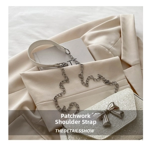 Macro view of sequined crossbody bag with silver bow clasp and chain strap