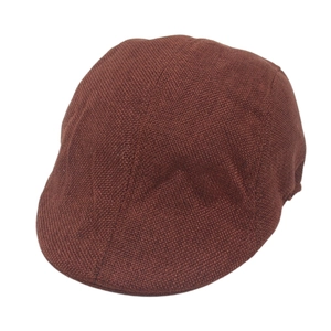Detailed close-up of dark brown flat cap showing vintage woven fabric texture