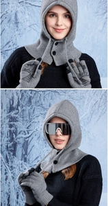 Close-up of grey knit hooded scarf with buttons and touchscreen gloves for skiing