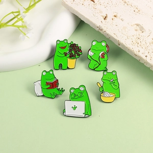 Set of 5 cartoon frog enamel pins showing gardening, music, reading, work, and cooking