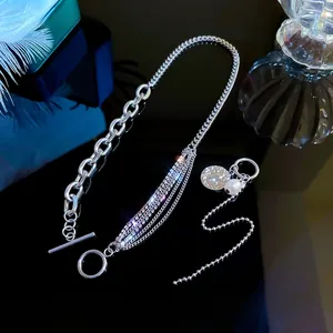 Detail view of silver OT buckle necklace with asymmetric pearls and rhinestones