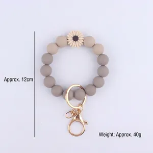 Taupe silicone bead wristlet keychain with white daisy charm and gold alloy ring