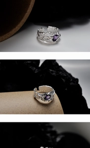 Detail of irregular textured S925 silver ring featuring a faceted purple gemstone