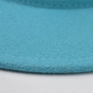 Macro detail of teal felt fedora hat showing refined fuzzy texture and stitching
