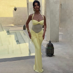 Close-up detail of the elegant ruched fabric and backless design on the yellow maxi dress