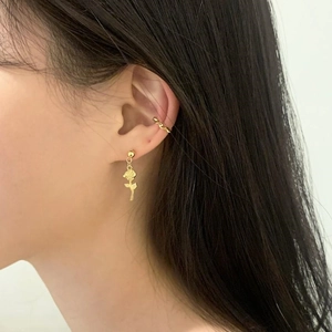 Close-up of gold rose stud earring and twisted ear cuff on ear for a minimalist look