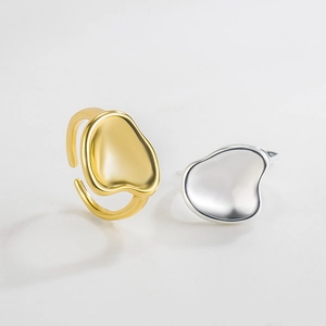 Macro shot of gold and silver irregular hammered texture rings with adjustable bands