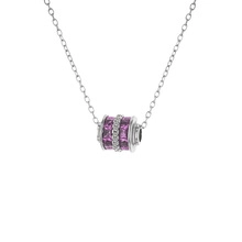 Close-up of silver cylinder pendant necklace with purple and white zircon stones