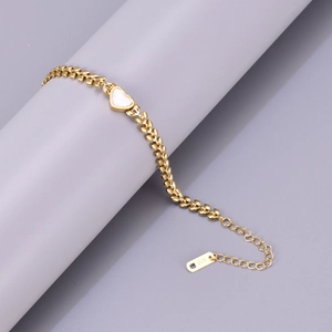 Detail of 18K gold-plated titanium bracelet with leaf chain and white heart inlay