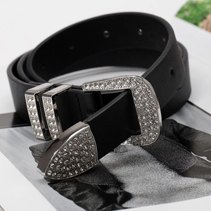 Black leather Y2K belt with sparkling rhinestone buckle on a fashion magazine