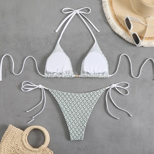 Detailed flat lay of green honeycomb bikini set with halter top and beach accessories