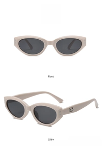 Detail view of pink cat eye sunglasses featuring stylish silver metal B logo on the temple