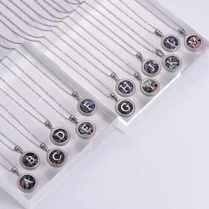 Silver stainless steel 26-letter shell pendant necklaces on acrylic display stand