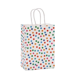 White paper gift bag with colorful polka dots and twisted handles for birthdays