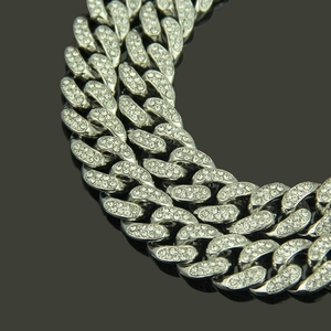 Macro shot of 13mm iced out silver Cuban link chain with dense diamond setting
