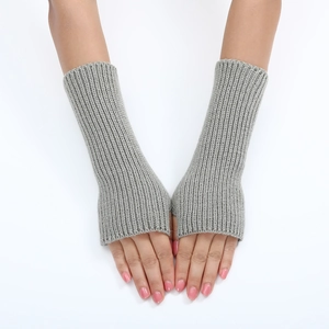 Close-up of grey ribbed knitted arm warmers showing texture and fingerless design