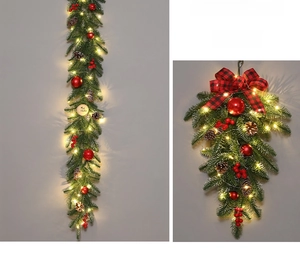 Detail of lighted Christmas teardrop swag with pine cones and red berries for holiday decor