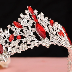 Macro shot of silver bridal crown featuring red marquise gems and sparkling rhinestones