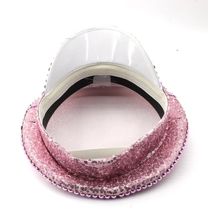 Detailed interior of pink sequin captain hat featuring white patent leather brim and lining