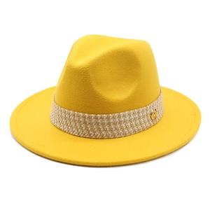 Detail of ginger yellow wool fedora hat with woven band and gold M buckle