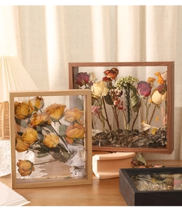 Detailed view of dried rose bouquet inside a natural wood shadow box frame