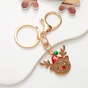 Close-up of a Christmas reindeer keychain with brown rhinestones and colorful enamel detail