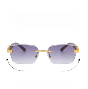 Detail of rimless sunglasses with purple gradient lenses and gold C-shaped metal hinges