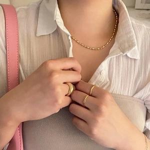 Elegant 925 silver beaded gold necklace and rings set worn by a female model