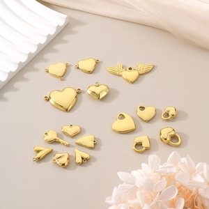 Detailed view of assorted golden heart-shaped pendants and wings for DIY jewelry crafting