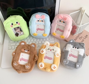 Detail of plush animal card holders with transparent windows on a laptop keyboard