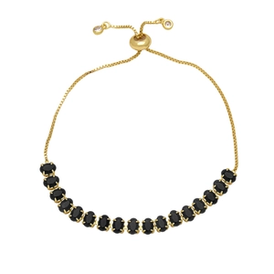 Adjustable golden bolo bracelet with oval black zircon stones and claw setting