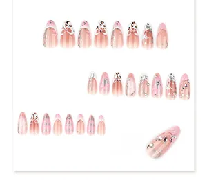 Detailed view of pink gradient almond nails with 3D bows, rhinestones and leopard patterns