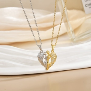 Detailed view of heart-shaped wing couple pendants with zircon pavé on beige fabric