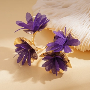 Detail of deep purple fabric flower earrings with elegant gold hoops and mesh petals