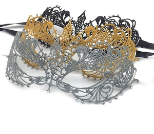 Detailed view of lace masquerade masks in gold, silver and black with sparkling rhinestones