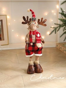 Detailed plush Christmas reindeer figurine in red and black plaid overalls with festive lights
