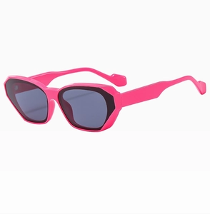 Detail of hot pink square sunglasses with thick geometric frames and dark lenses