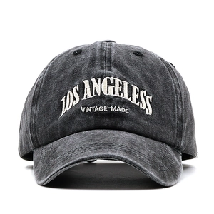 Detailed close-up of vintage embroidered Los Angeles lettering on a gray washed cotton cap