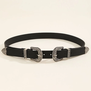 Detail of western style double buckle belt featuring ornate silver floral engravings