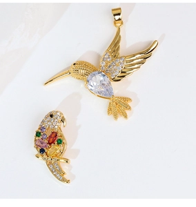 Detail showing bird-shaped gold charms with colorful zircon inlay for DIY jewelry