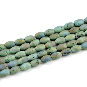 Macro shot of oval green druzy agate beads with natural mineral crystal textures