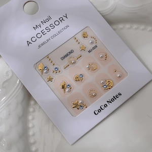 Marine theme nail art set with gold starfish, shells, pearls and blue rhinestones