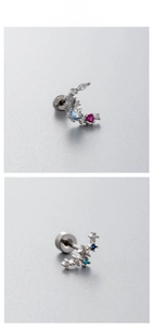 Macro shot of titanium steel moon and starburst stud earrings with colorful zircon stones