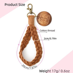 Detail view of brown cotton braided keychain with metal clasp and MAMA wood tag