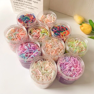 Colorful elastic hair bands for girls in clear jars with fresh tulip decorations