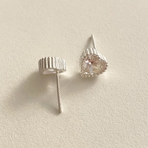 Close-up of S925 sterling silver heart stud earrings with sparkling cubic zirconia stones