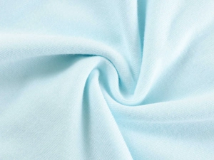 Macro view of light blue knitted modal fabric with soft texture and fine ribbed details
