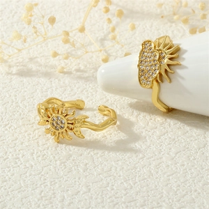 Detailed close-up of 18K gold plated celestial rings with sun and moon zircon settings