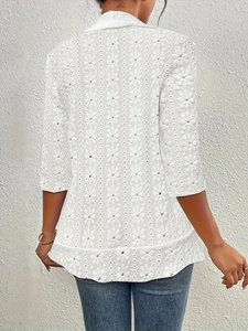 Back view of elegant white lace blazer featuring hollow-out floral patterns and mid-sleeves